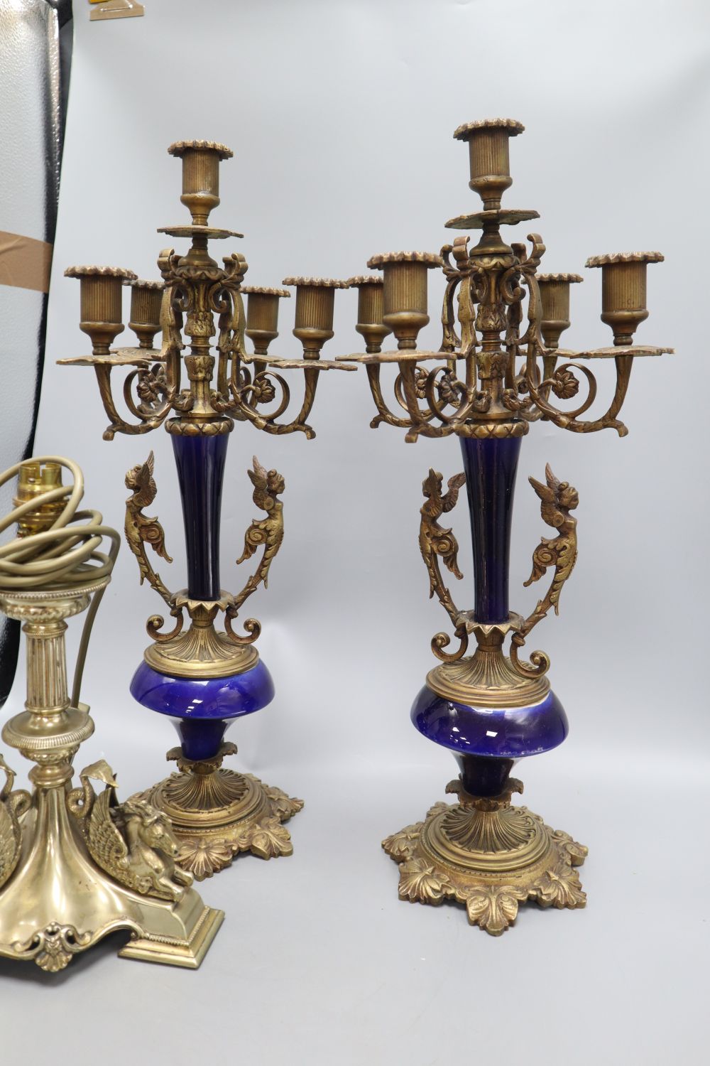 A pair of gilt metal and porcelain five light candelabra, height 50cm, a table lamp and a kettle on stand